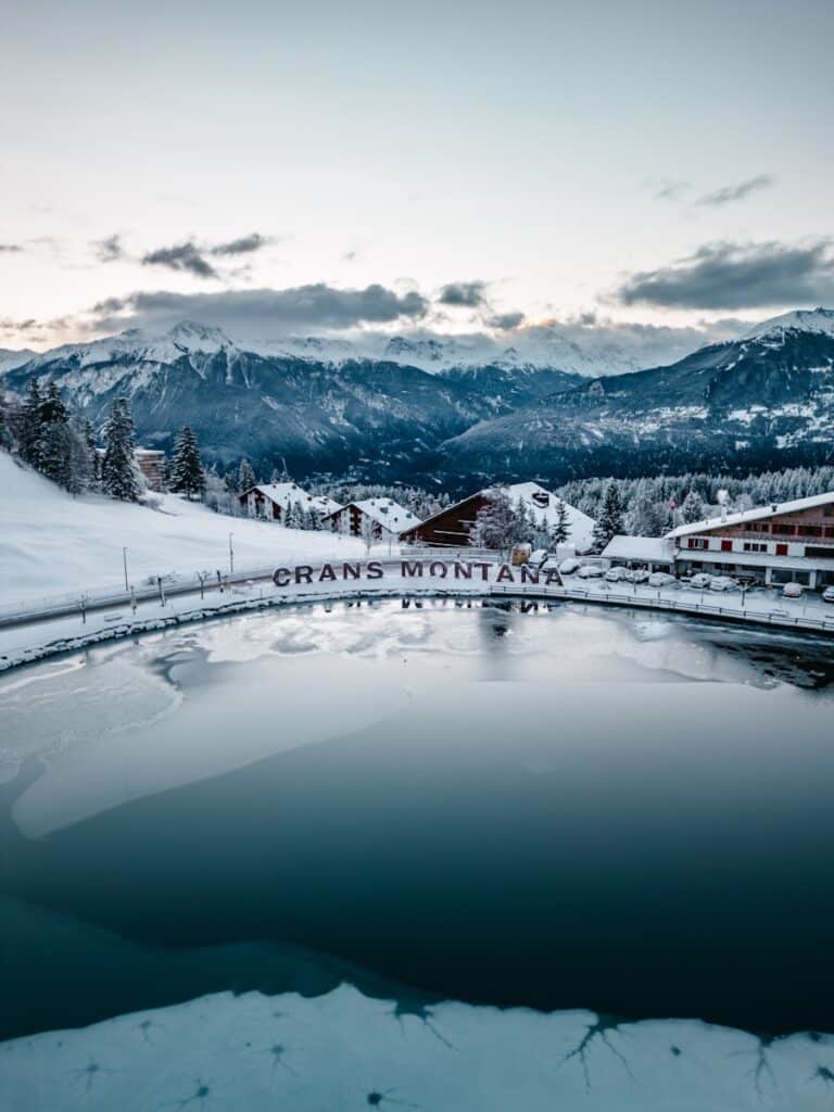 Crans-Montana - a lake surrounded by snow covered mountains
