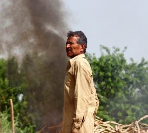 Pakistani airstrikes  - a man standing in front of a black cloud of smoke