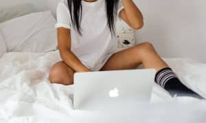 Onlyfans woman sitting on bed