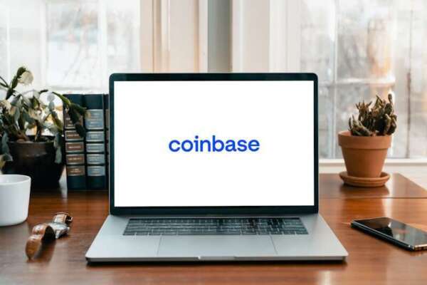Coinbase Oracle Sacks 1 in 7 Staff for AI via 5:30 AM Email a laptop on a table