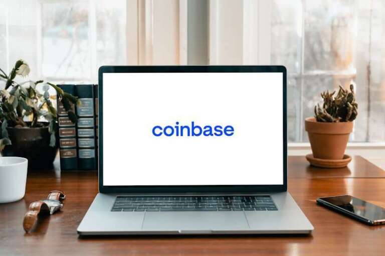 Coinbase Oracle Sacks 1 in 7 Staff for AI via 5:30 AM Email a laptop on a table